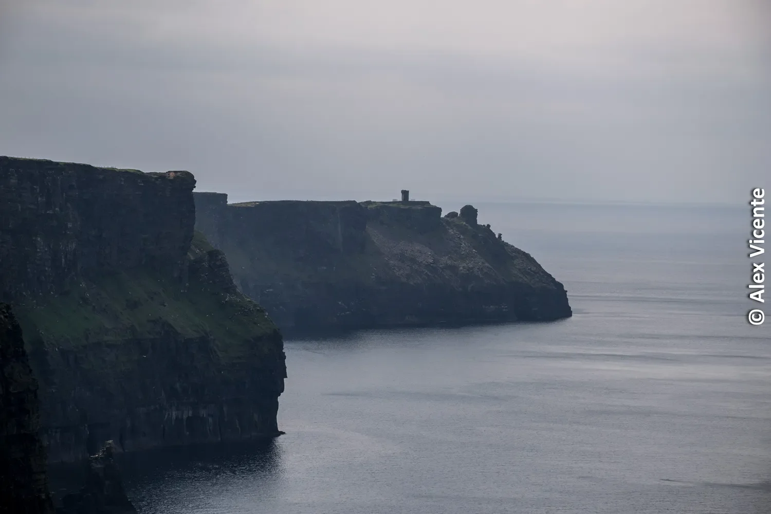 The Cliffs of Moher fading into mist above the Atlantic