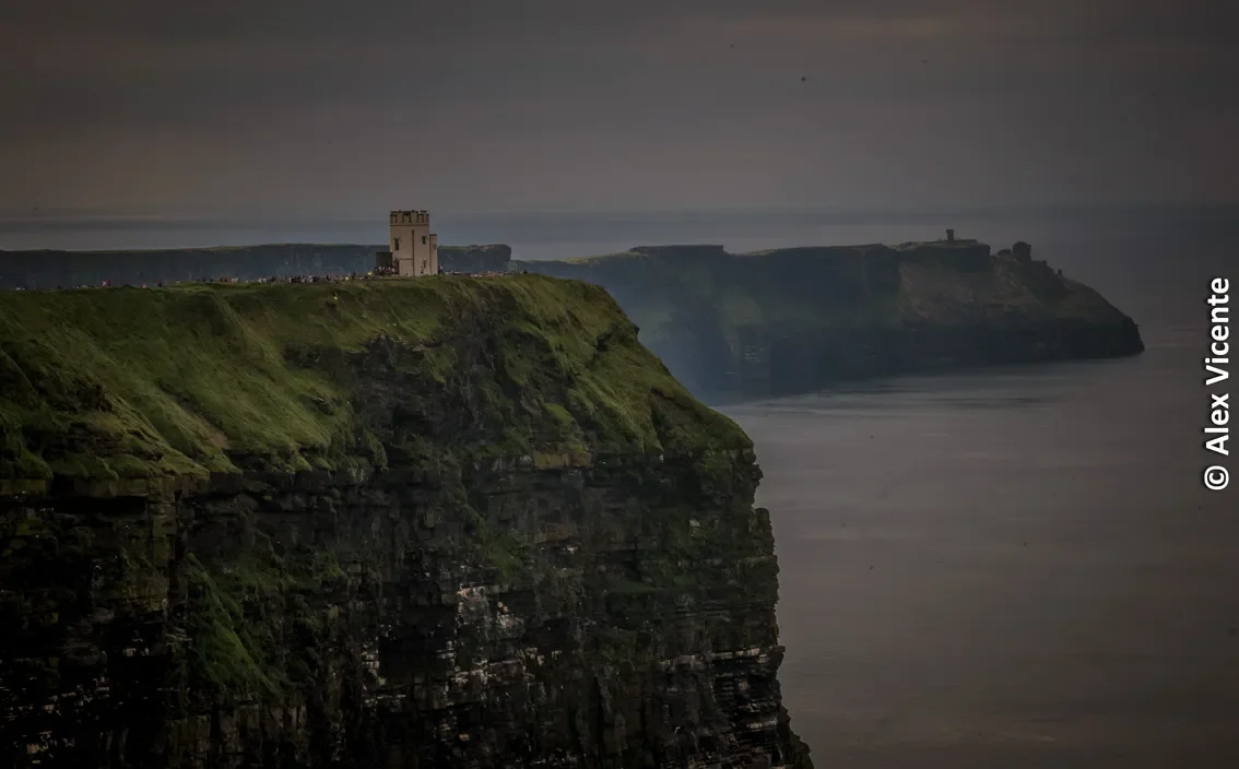 A tower and cliffs fading into Atlantic mist.