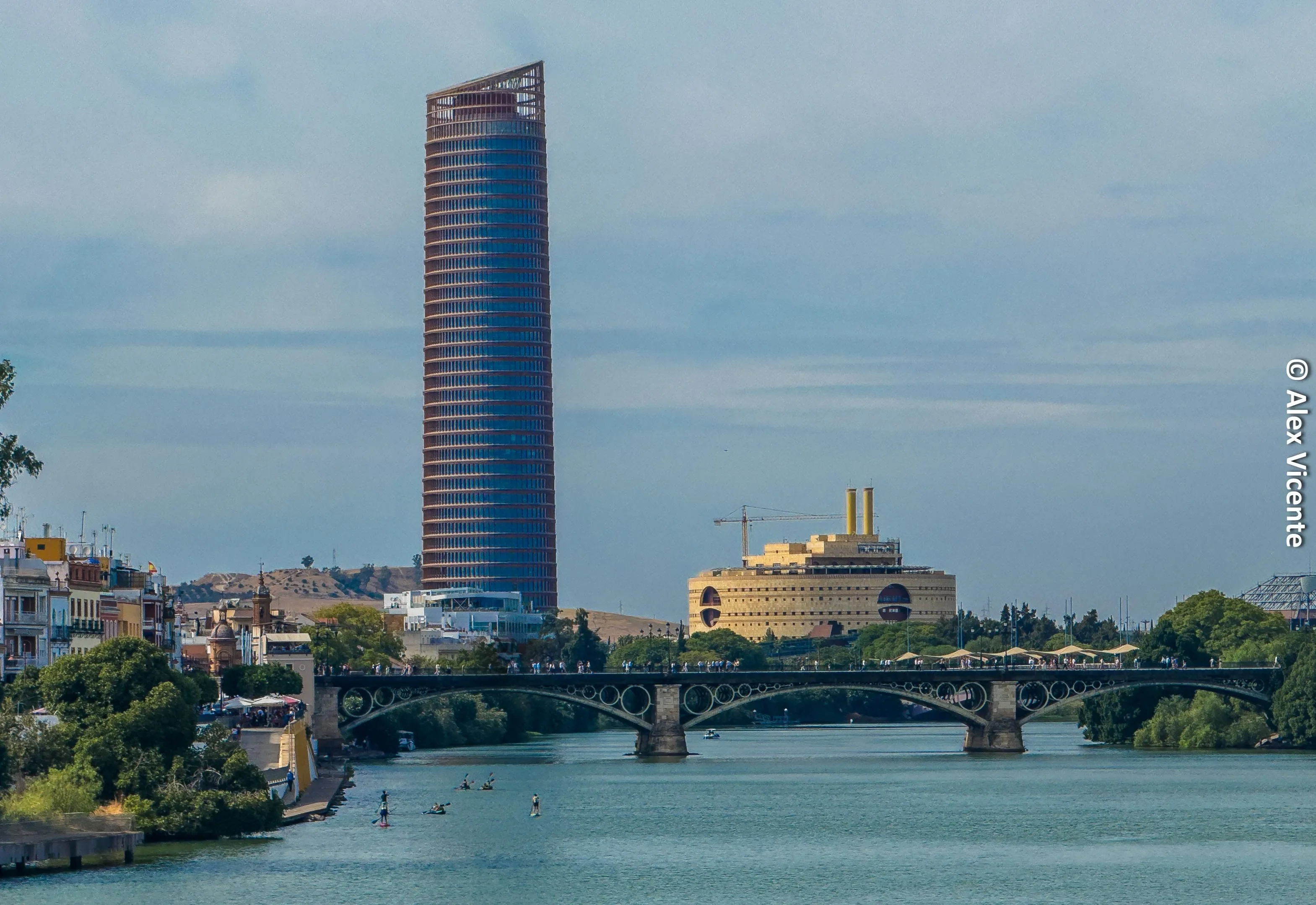 Aerial view of Seville, its river, bridges and towers.